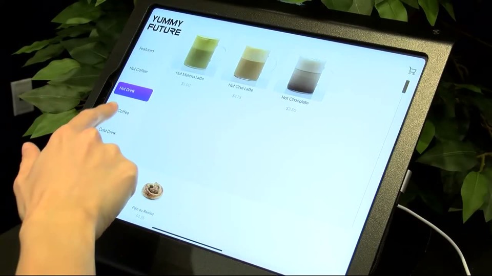 Finger tapping a drink on the order screen